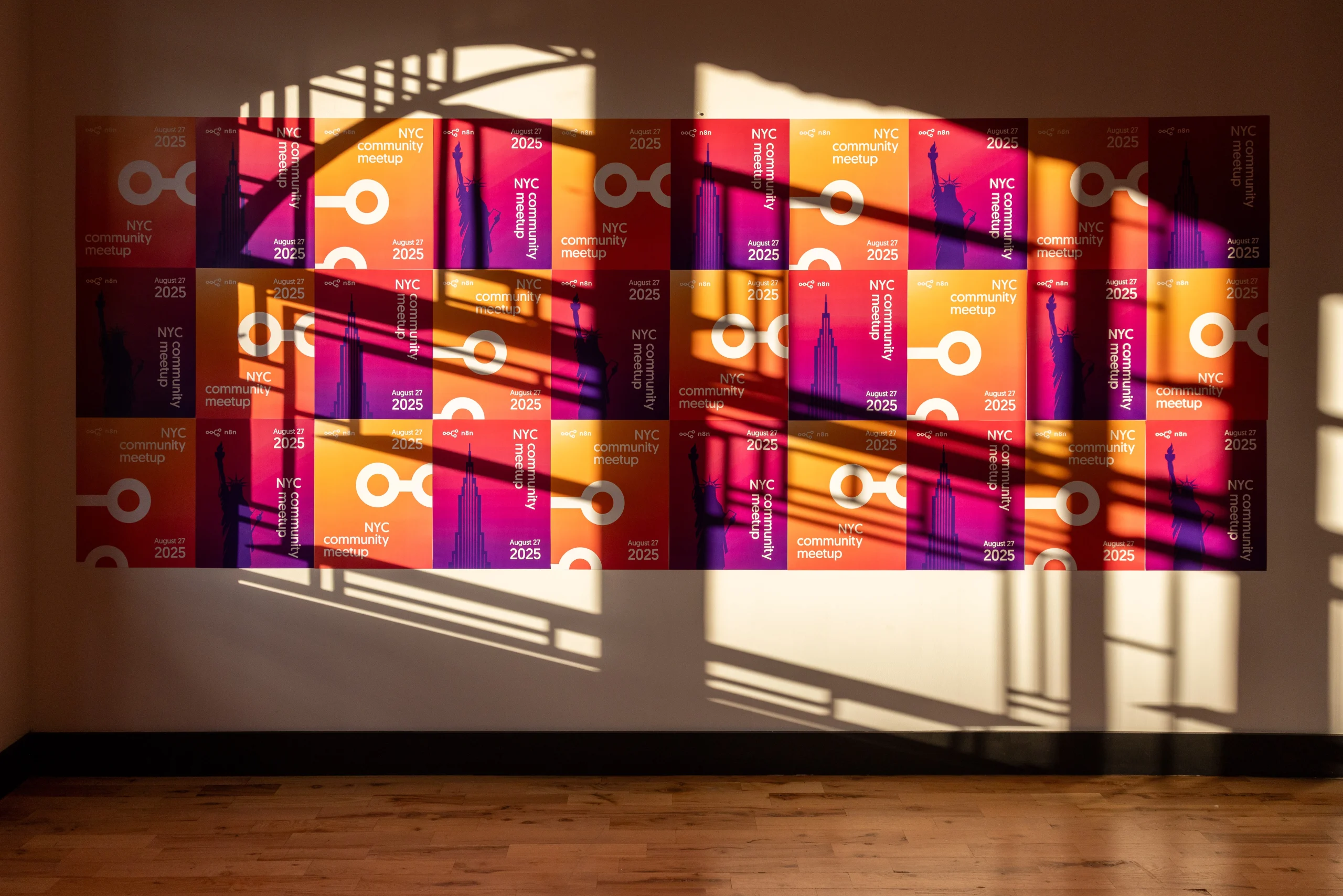 A colorful wall display promoting an NYC community meetup event, with shadows creating an interesting pattern.