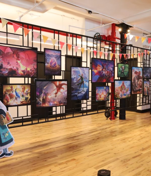A vibrant exhibition space showcasing colorful artwork and a character cutout.
